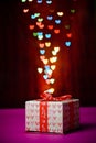 Gift box open shaped heart with Defocused bokeh colorful lights Royalty Free Stock Photo
