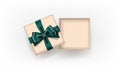 Gift box open square decorated with bow-ribbon green on white background. Craft style. Top view. Royalty Free Stock Photo