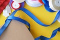 Gift box packaging on a yellow background. A lot of bright satin ribbons Royalty Free Stock Photo