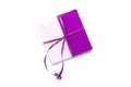 Gift box, parcel in wrapping paper tied with purple color ribbon, packaging mock up on white