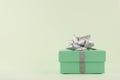 Gift Box, Pastel Green gift box with Silver ribbon and bow on light green background Royalty Free Stock Photo