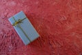 Gift box on Peach color rough background