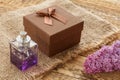Gift box with perfume and flowers on the wooden background Royalty Free Stock Photo