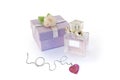 Gift box, perfume glass bottle and chain with heart Royalty Free Stock Photo