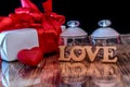 Gift box and perfumes as valentine presents on dark