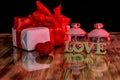 Gift box and perfumes as valentine presents on dark