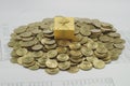 Gift box on a pile of gold coins Royalty Free Stock Photo
