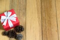 Gift box and pine cones on wood table with copy space Royalty Free Stock Photo