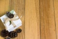 Gift box and pine cones on wood table with copy space Royalty Free Stock Photo