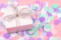 Gift box on pink background with confetti Royalty Free Stock Photo