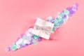 Gift box on pink background with confetti Royalty Free Stock Photo