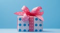 a gift box with pink bow on sky blue background Royalty Free Stock Photo