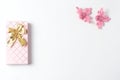 Gift box of pink color with a bow of gold, two beautiful figures of birds. blank space for a text, flat lay