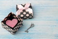 Gift box with pink heart and key on the blue wooden background. Valentine`s Day. space for text Royalty Free Stock Photo