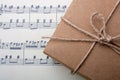 Gift box placed on paper with musical notes Royalty Free Stock Photo