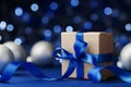 Gift box or present and christmas balls against blue bokeh background. Magic holiday greeting card. Royalty Free Stock Photo