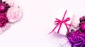 Gift box present decorations flatlay. Gift pink ribbon pink purple flowers top view. Congratulation template long banner