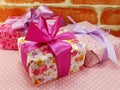 Gift box present with pink ribbon bow on pink polka dot Royalty Free Stock Photo