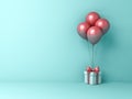 Gift box or present box with red pink pastel color balloons isolated on light green blue pastel color background Royalty Free Stock Photo