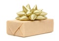 Gift box with present wrapped in kraft paper and with golden light beige bow isolated on the white background, gift ribbon bow Royalty Free Stock Photo