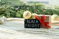 Gift box and promotional sign of black Friday on the Christmas background. Black friday design, super sale, discount Royalty Free Stock Photo