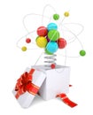 Gift box with red band and colorful atom structure