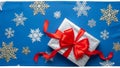Gift Box with Red Bow on Blue Snowflake Pattern Background Royalty Free Stock Photo