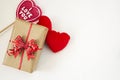 Gift box with red bow, red fluffy hearts and heart shaped lollipop.