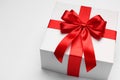 Gift box with red bow on light grey background, closeup. Space for text Royalty Free Stock Photo