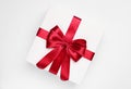 Gift box with red bow on light grey background, top view Royalty Free Stock Photo