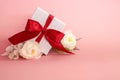 Gift box with red bow on a pink background . valentine `s or Mother`s or Women `s  day celebration concept Royalty Free Stock Photo