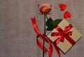 Gift box with a red bow, pink rose and aroma candles white shape of heart. Top view Space for text