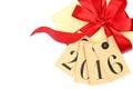 Gift box with red bow and tags with new year 2016 Royalty Free Stock Photo