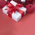 Gift box with red bow, tinsel, and knitted stars close-up. Gift concept for needlewoman Royalty Free Stock Photo