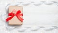 Gift box with red bow on wooden table. Christmas background with festive decoration. Place for your text. copyspace. top Royalty Free Stock Photo