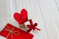 Gift box with a red heart inside on a white old wooden table. Va