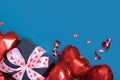 Gift box and red heart shape baloons on blue background. Valentines Day greeting card. Copy space Royalty Free Stock Photo