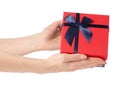 Gift box with a red lid and a blue bow in hand Royalty Free Stock Photo