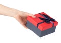 Gift box with a red lid and a blue bow in hand Royalty Free Stock Photo