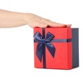 Gift box with a red lid and a blue bow in hand Royalty Free Stock Photo