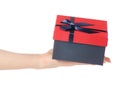 Gift box with a red lid and a blue bow in hand Royalty Free Stock Photo