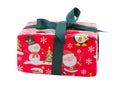 A gift box, in red paper with a print of Santa and a snowman and with a green ribbon. Isolated.