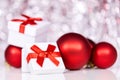 Gift box with red ribbon and christmas balls, festive background Royalty Free Stock Photo