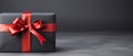 Gift box with red ribbon on grey background