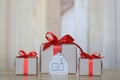 Gift box with red ribbon and house model with keys on wooder background, Gift new home and Real estate concept Royalty Free Stock Photo