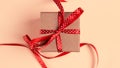 Gift box with red ribbon over pink paper background Royalty Free Stock Photo