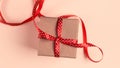 Gift box with red ribbon over pink paper background Royalty Free Stock Photo