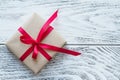 Gift box with red ribbon on the rustic background Royalty Free Stock Photo