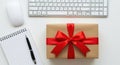 Gift box with red ribbon on a white desk Royalty Free Stock Photo