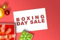 Gift box with a ribbon and Christmas ornament with Boxing Day Sale text on paper Royalty Free Stock Photo